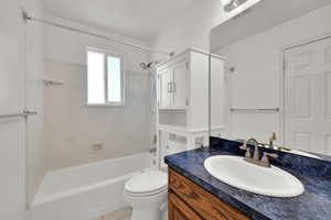 Bathroom featuring vanity, tub / shower combination, and light tile patterned floors