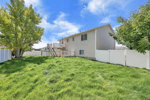 Back of property featuring stairway, a fenced backyard, and a wooden deck