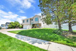 Bi-level home with a garage and driveway