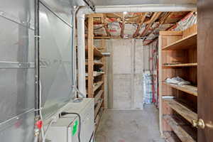Unfinished basement featuring heating unit