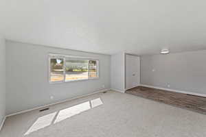 Spare room featuring carpet flooring