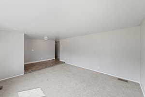 Carpeted spare room with baseboards