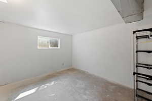 Empty room featuring unfinished concrete floors