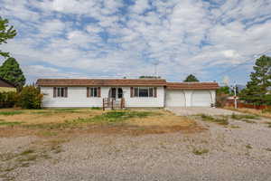 Ranch-style home with driveway and an attached garage