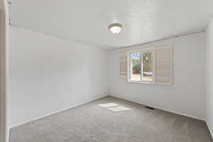 Unfurnished room featuring carpet and baseboards