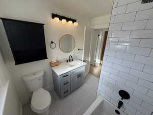 Bathroom featuring vanity, light tile patterned flooring, and shower / tub combination