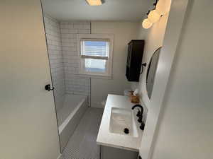 Full bathroom featuring vanity,  shower combination, and tile patterned floors