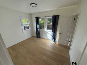 Unfurnished room featuring plenty of natural light and light wood-type flooring