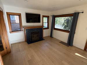 Unfurnished living room with a fireplace and light wood-style floors