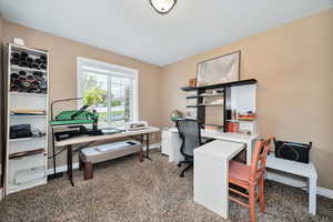 Office/bedroom 2 area featuring light carpet and baseboards