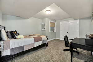 Bedroom 3 featuring carpet flooring, a textured ceiling, a closet, and an office area