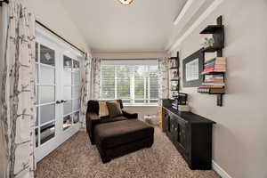 Master bedroom sitting room with carpet and french doors