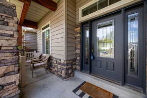 View of exterior entry with stone siding