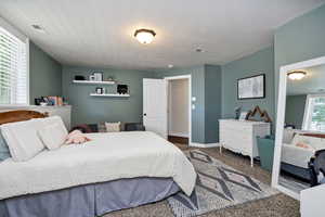 Bedroom 6 with carpet flooring and a textured ceiling