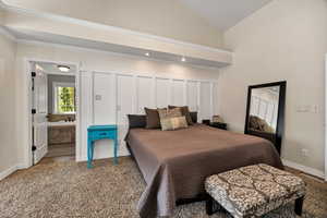 Master bedroom with carpet, crown molding, and high vaulted ceiling