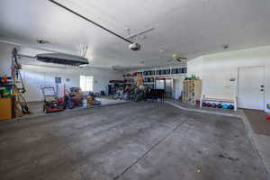 3 car garage featuring a ceiling fan