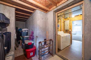 Below grade area featuring electric panel and separate washer and dryer