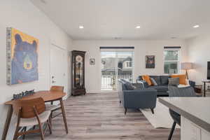 Living area with recessed lighting and light wood-style floors