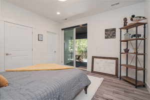 2nd bedroom with full ensuite bathroom, access to the back deck, LVP finished floors and recessed lighting.
