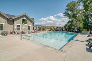 Seasonal community pool with a patio area