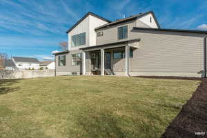 Back of house featuring board and batten siding and a patio