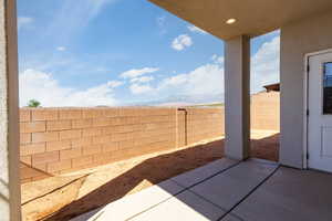 Fenced backyard with a patio