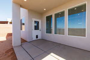 Doorway to property with a patio and stucco siding