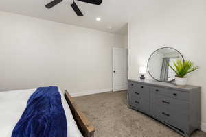 Bedroom with light colored carpet, a ceiling fan, and recessed lighting