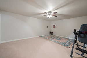 Workout room with carpet floors and ceiling fan