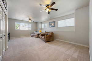 Living room with light carpet and a ceiling fan