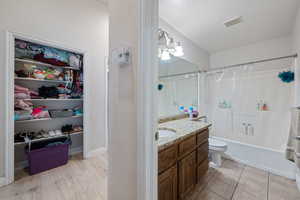 Full bathroom featuring shower / tub combo, vanity, and light tile patterned floors