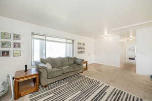 Living area featuring light colored carpet