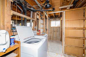 Below grade area featuring washing machine and clothes dryer