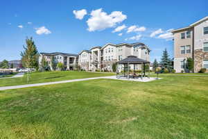 Surrounding community with a gazebo, a yard, and a patio