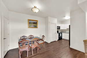 Dining room with dark wood-style floors