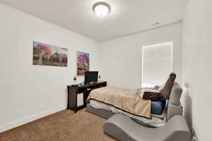 Carpeted bedroom with baseboards