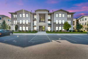 Property at dusk with uncovered parking