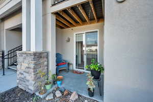 Entrance to property with stucco siding