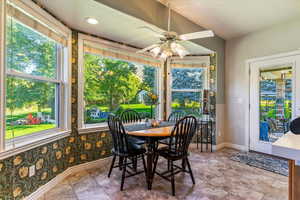 Dining space with plenty of natural light and a ceiling fan