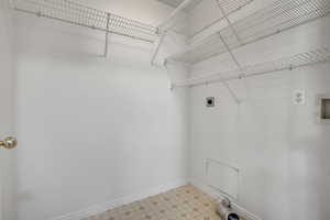 Laundry area with electric dryer hookup, light floors, and hookup for a washing machine