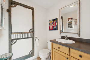 Half bath featuring vanity and toilet