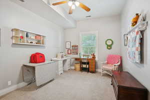 Office space featuring light colored carpet and a ceiling fan