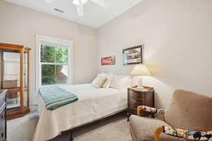 Carpeted bedroom with ceiling fan
