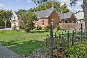 View of front facade featuring brick siding, a garage, driveway, and a shingled roof