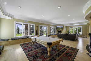 Playroom with crown molding, billiards, light wood-style floors, healthy amount of natural light, and recessed lighting