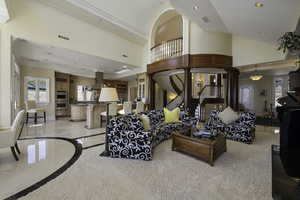 Living area with stairway, recessed lighting, a towering ceiling, inlaid floor details, and crown molding