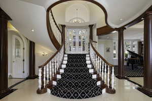 Entrance foyer featuring ornate columns, french doors, recessed lighting, a chandelier, and light tile patterned floors