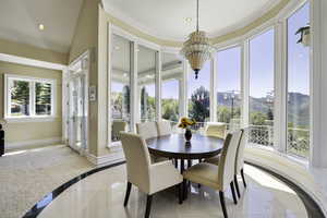 Dining area with inlaid floor details, recessed lighting, and light tile patterned floors