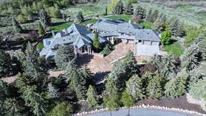 Aerial view of property's location featuring a tree filled landscape