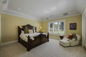 Carpeted bedroom featuring crown molding, recessed lighting, and a tray ceiling